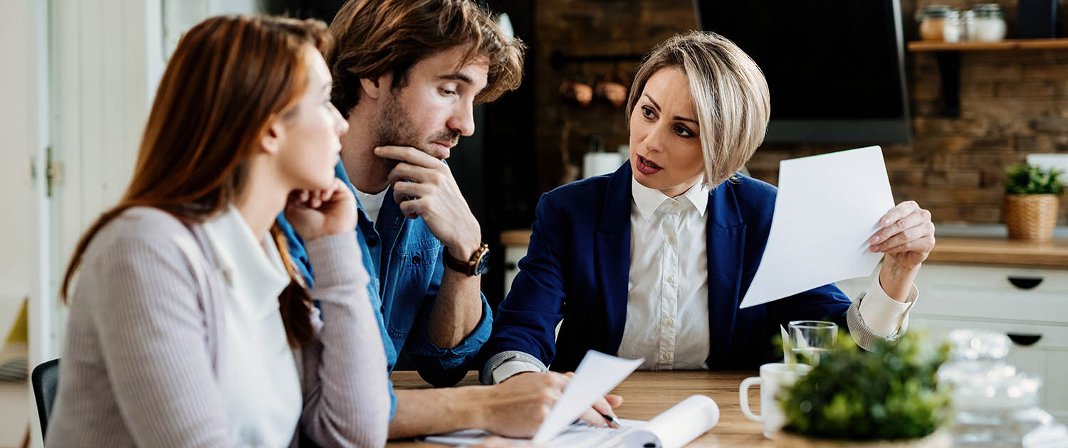 Insurance agent talking to a couple about terms of their lease a